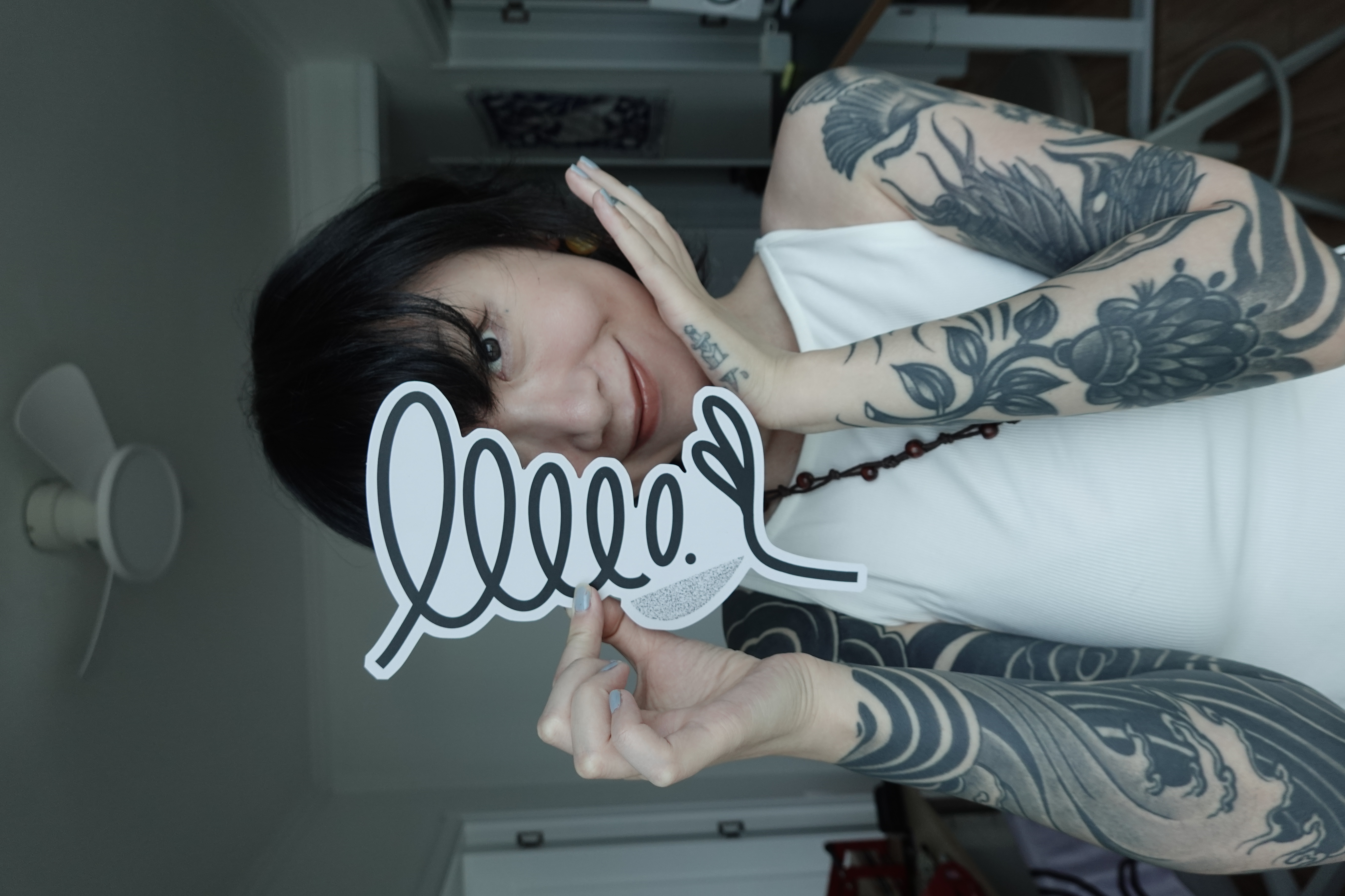 sese holding a large sticker