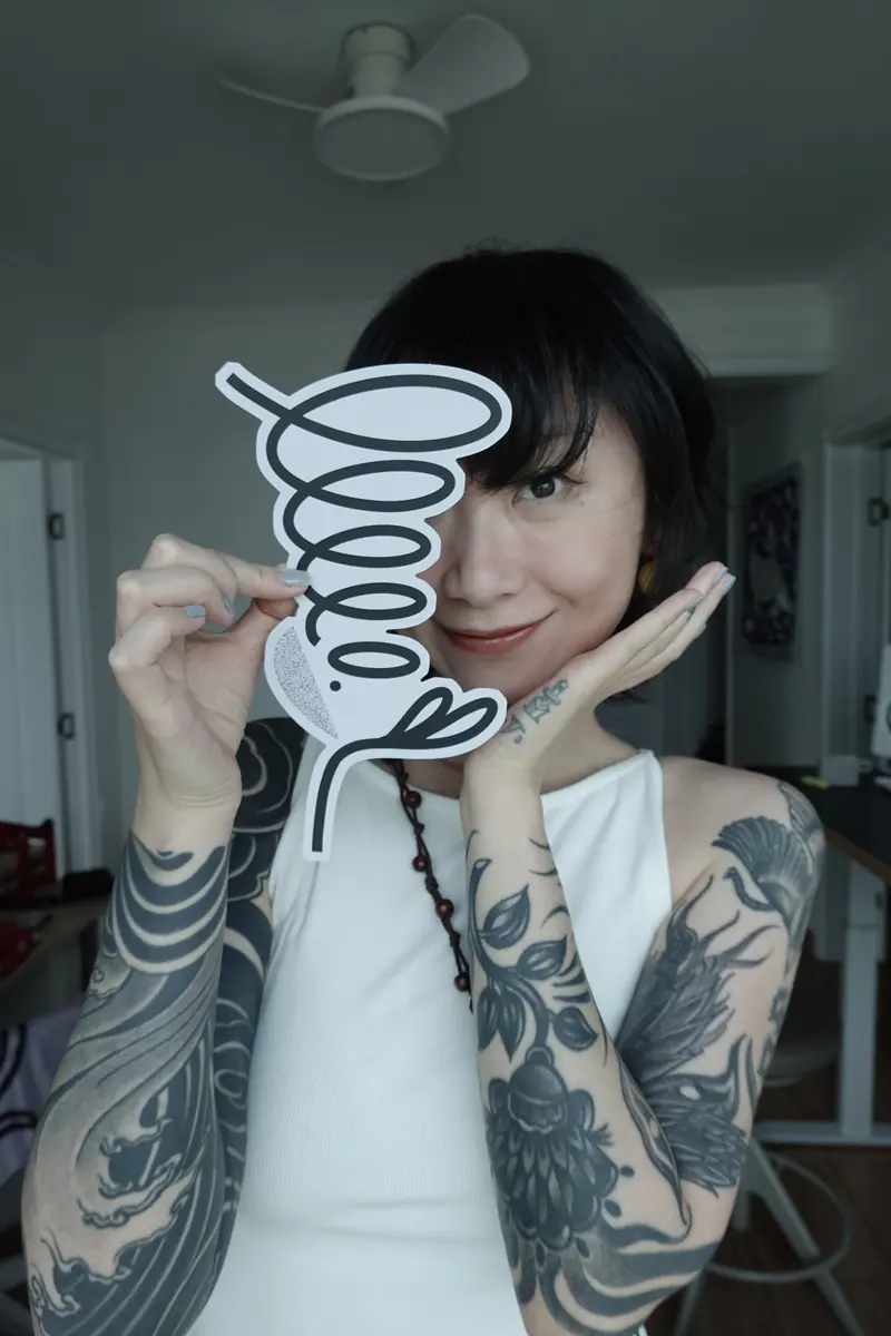 sese holding a large sticker